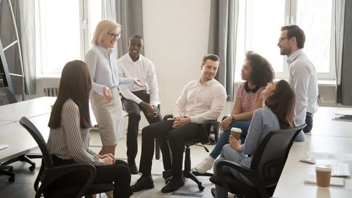 shutterstock_1492319855 - STOCKPAID - Mature,Businesswoman,Holding,Business,Briefing,Diverse,Employees,Coach,Training Mature,Businesswoman,Holding,Business,Briefing,Diverse,Employees,Coach,Training